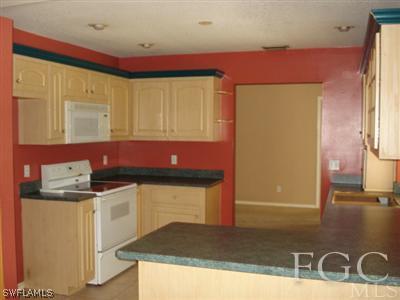17517 Allentown Road Fort Myers, FL 33967 - Photo 2 of 9 a kitchen with stainless steel appliances granite countertop a sink stove and cabinets