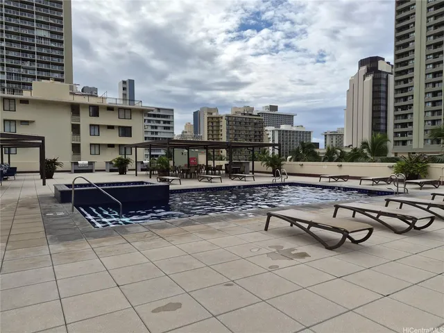 a view of a swimming pool with outdoor seating