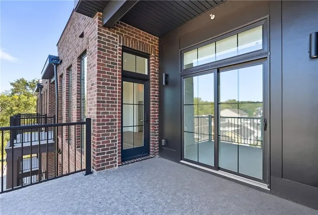 a kitchen with stainless steel appliances kitchen island granite countertop a refrigerator a stove a sink dishwasher with a dining table and chairs with wooden floor