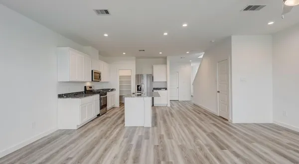 a view of kitchen with wooden floor