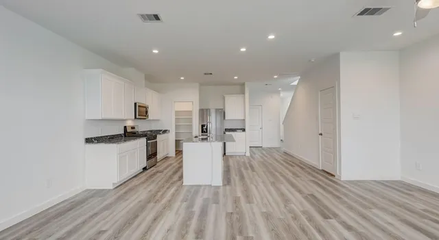 a view of kitchen with wooden floor