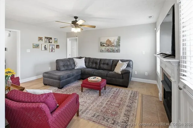 a living room with furniture fireplace and window