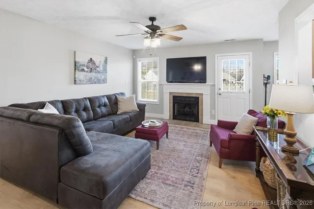 a living room with furniture or chandelier and a fireplace