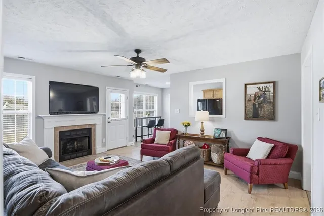 a living room with furniture flat screen tv and a fireplace