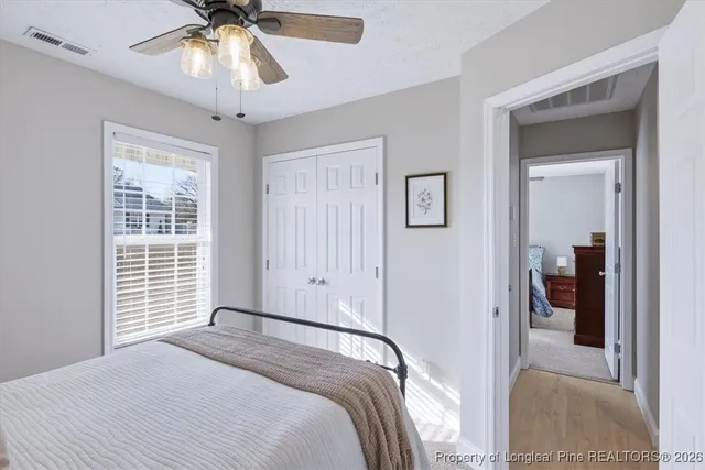 a bedroom with a large bed and a chandelier