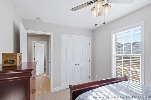 a bedroom with a bed dresser and a window