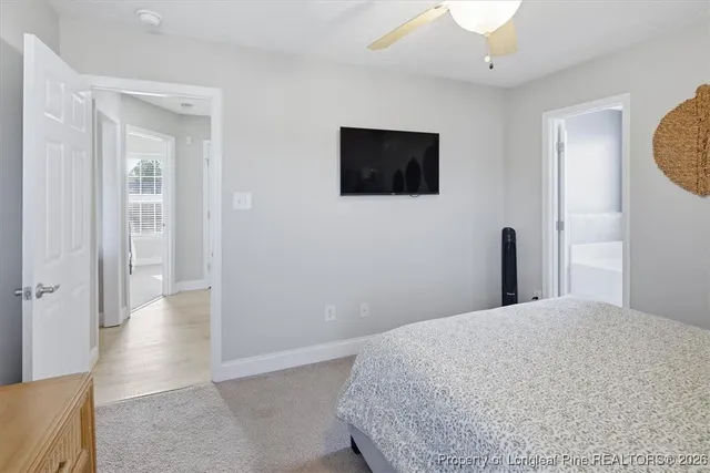 a view of a livingroom with wooden floor and a flat screen tv