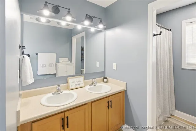 a bathroom with a double vanity sink and a mirror