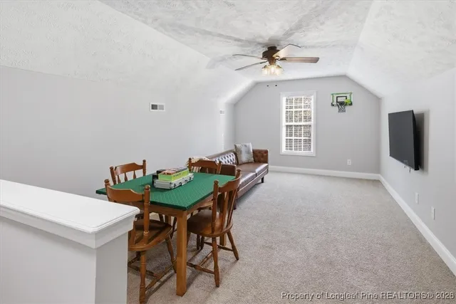 a view of a dining room with furniture and a chandelier