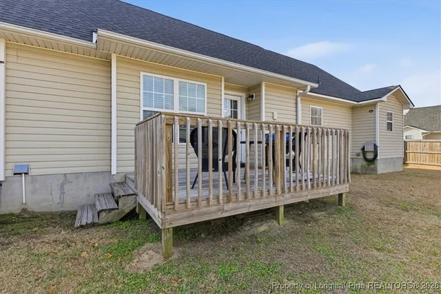 a view of a house with wooden fence