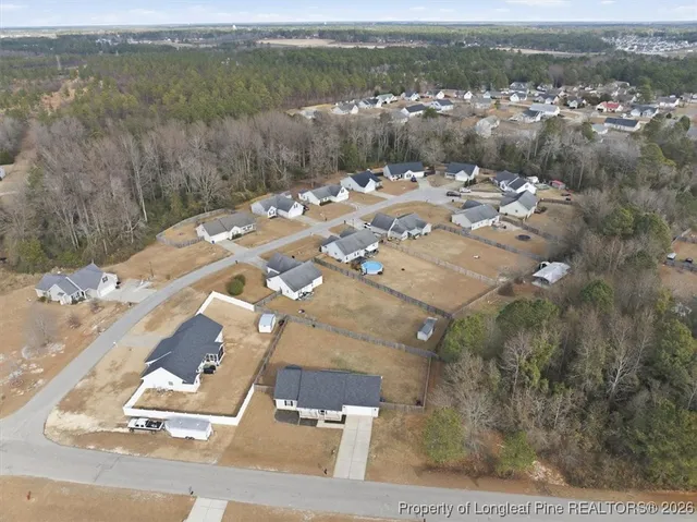 an aerial view of a house with a lake view