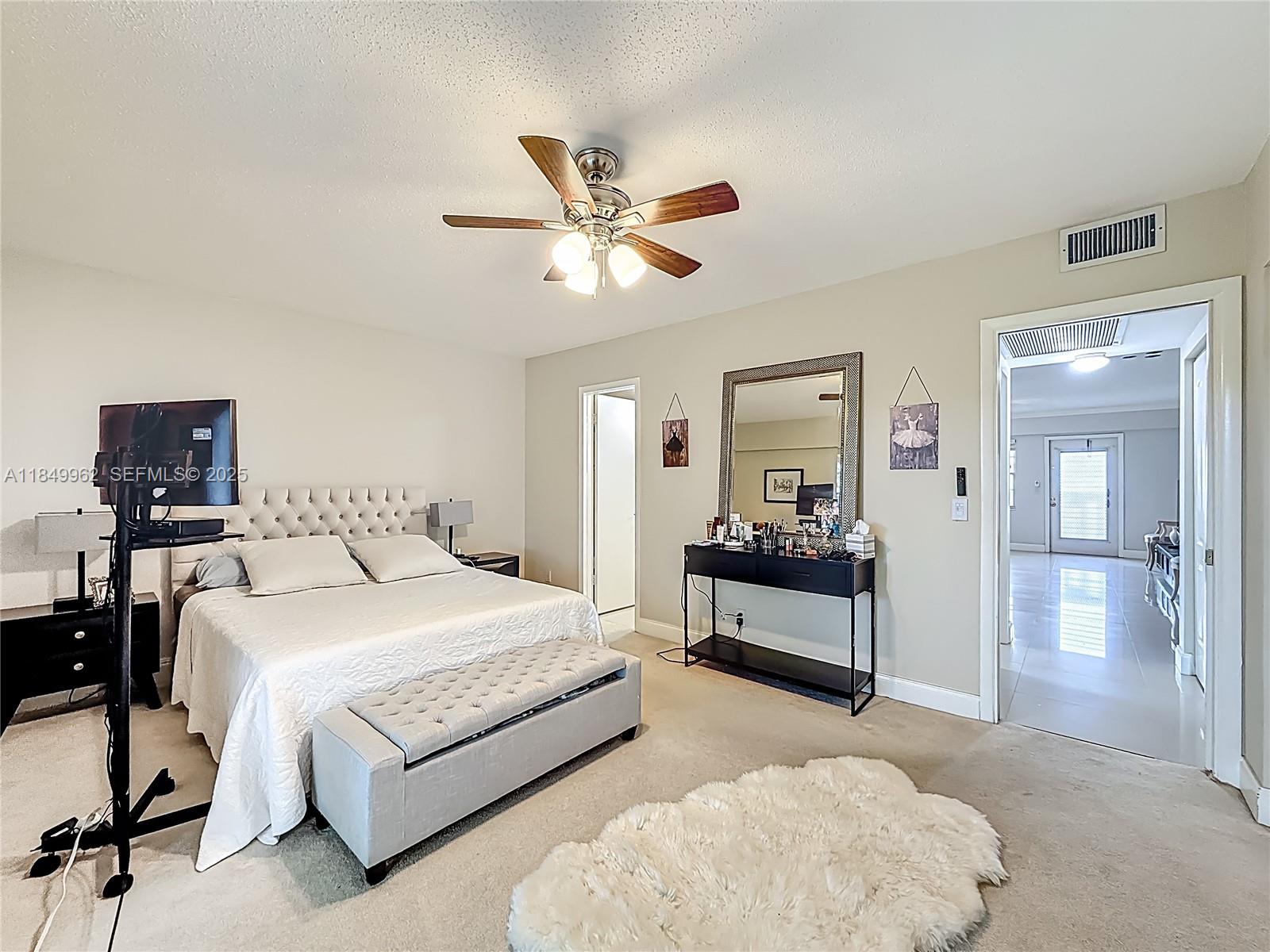 618 Fanshaw O, Unit 618 Boca Raton, FL 33434 - Photo 24 of 40 a bedroom with a bed and a chandelier