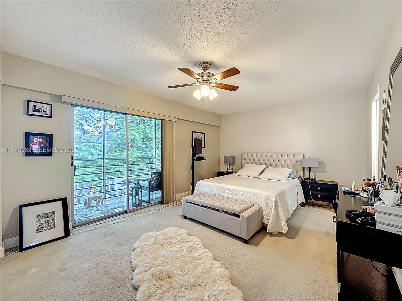 618 Fanshaw O, Unit 618 Boca Raton, FL 33434 - Photo 26 of 40 a spacious bedroom with a large bed and a chandelier