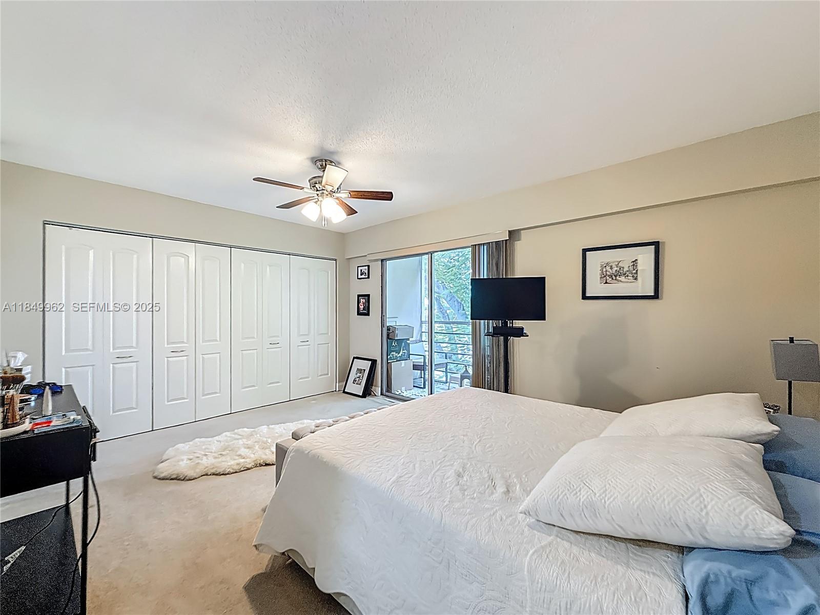 618 Fanshaw O, Unit 618 Boca Raton, FL 33434 - Photo 28 of 40 a spacious bedroom with a bed and a chandelier