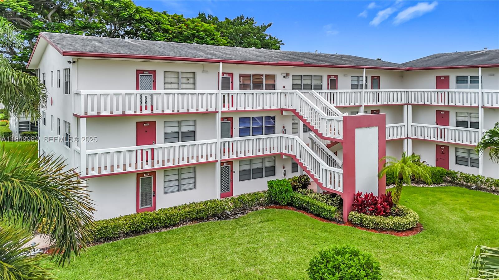 618 Fanshaw O, Unit 618 Boca Raton, FL 33434 - Photo 3 of 40 a front view of a house with a yard and potted plants