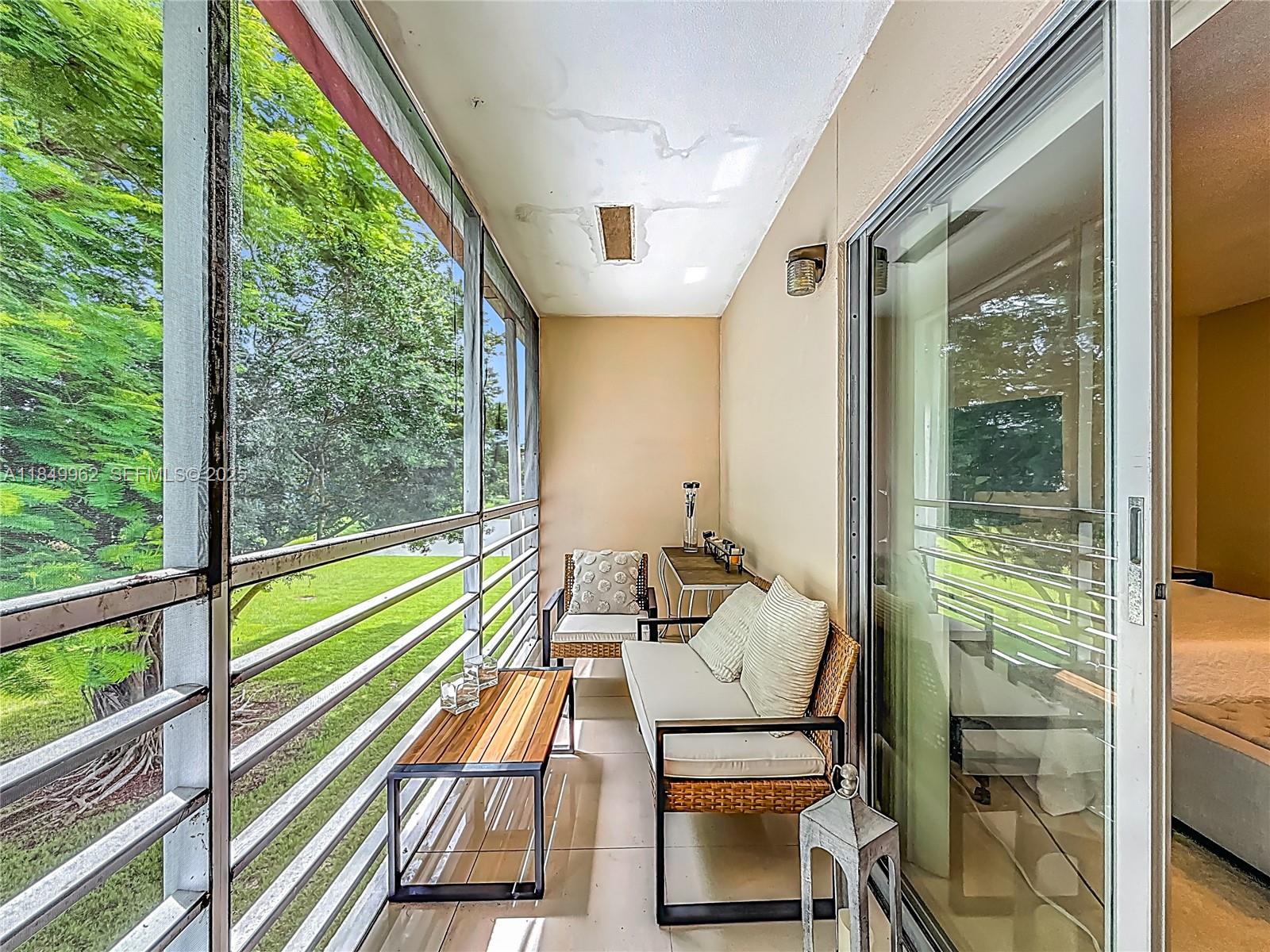 618 Fanshaw O, Unit 618 Boca Raton, FL 33434 - Photo 31 of 40 a sitting area with furniture and a balcony