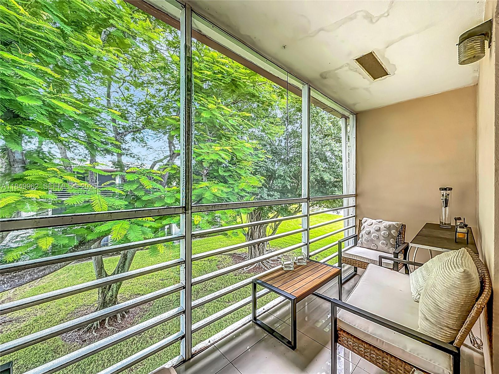 618 Fanshaw O, Unit 618 Boca Raton, FL 33434 - Photo 32 of 40 a view of a balcony with chair and wooden floor