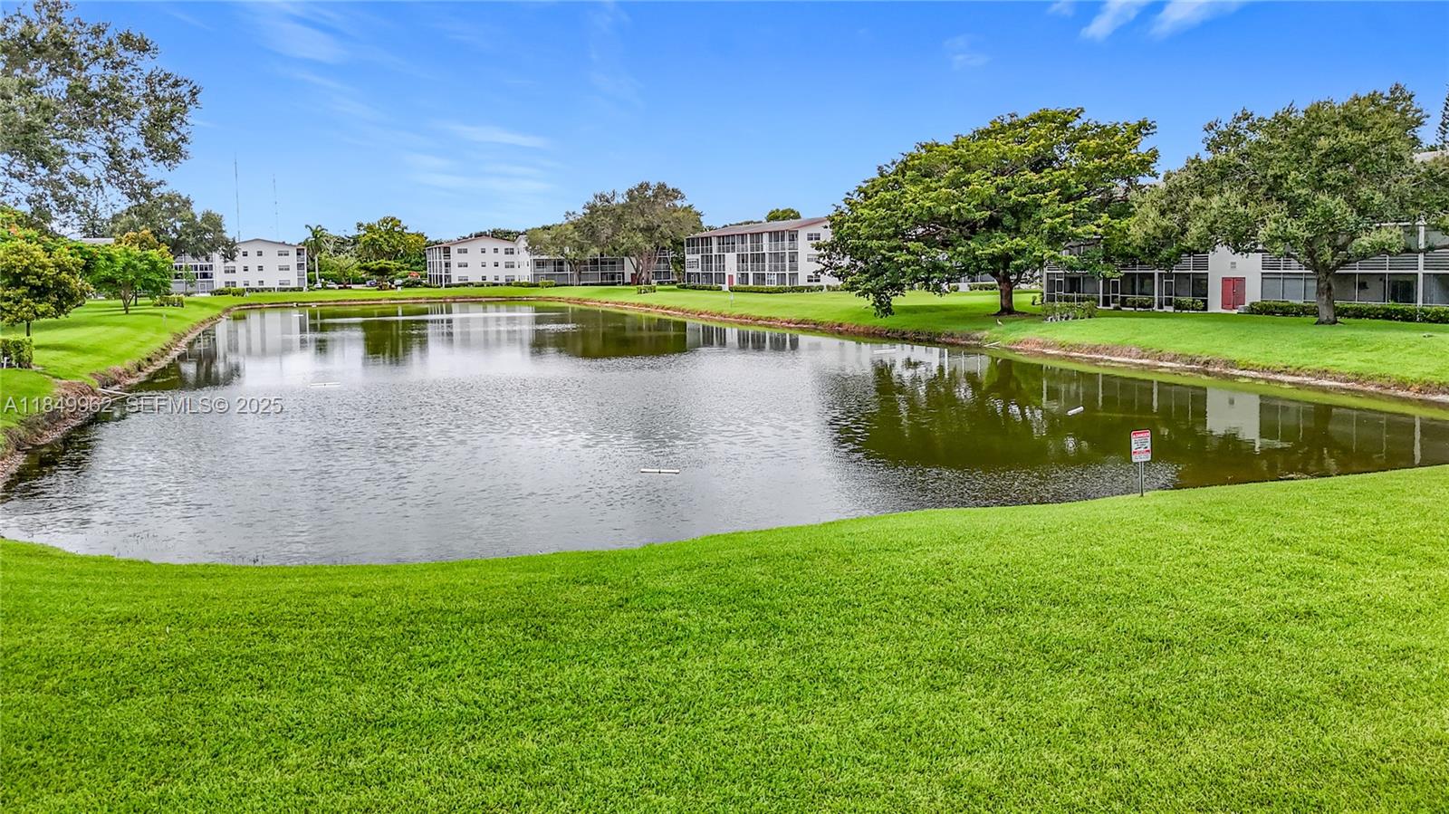 618 Fanshaw O, Unit 618 Boca Raton, FL 33434 - Photo 34 of 40 a view of a lake with a large trees