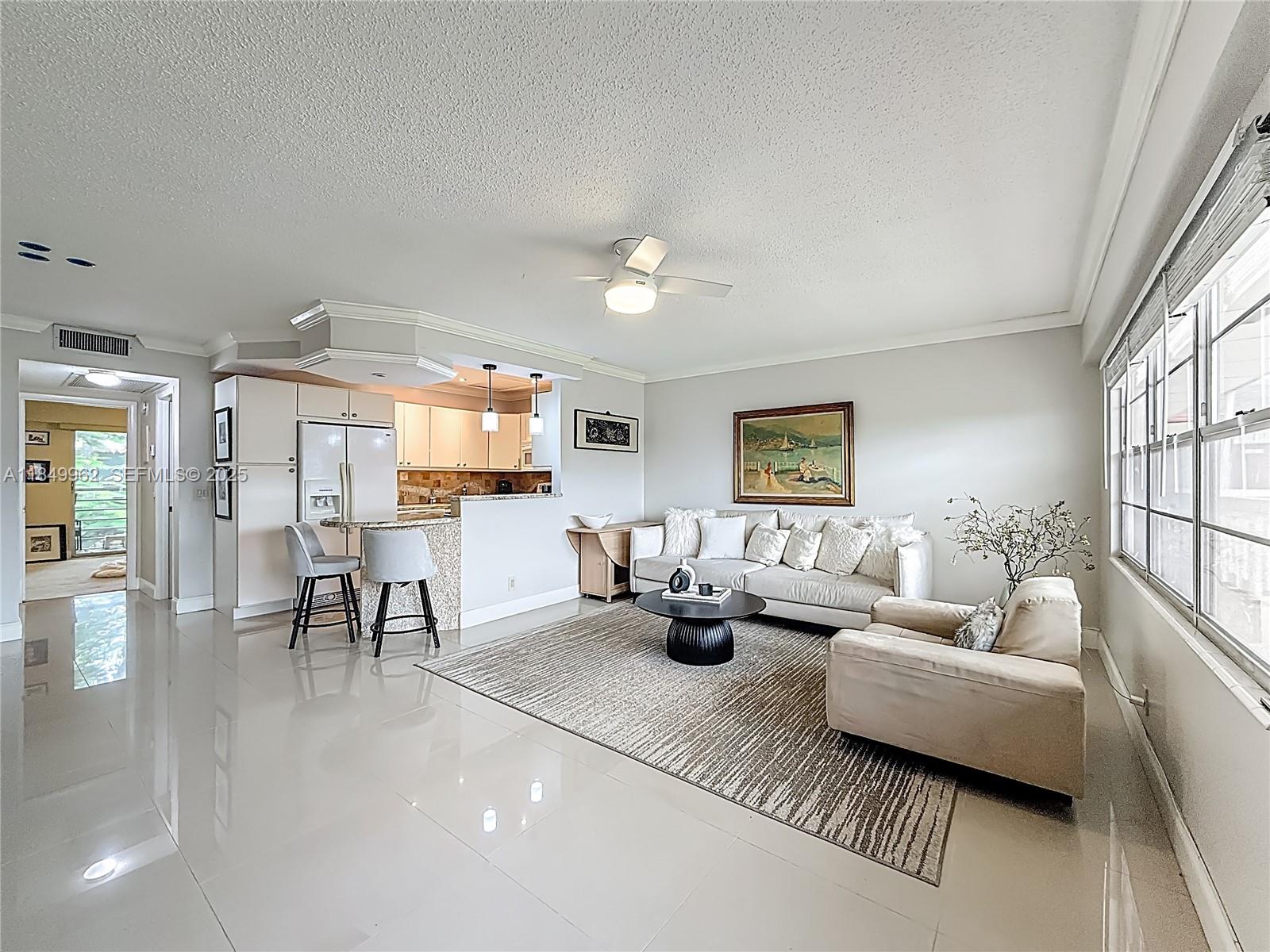 618 Fanshaw O, Unit 618 Boca Raton, FL 33434 - Photo 7 of 40 a living room with furniture and a window