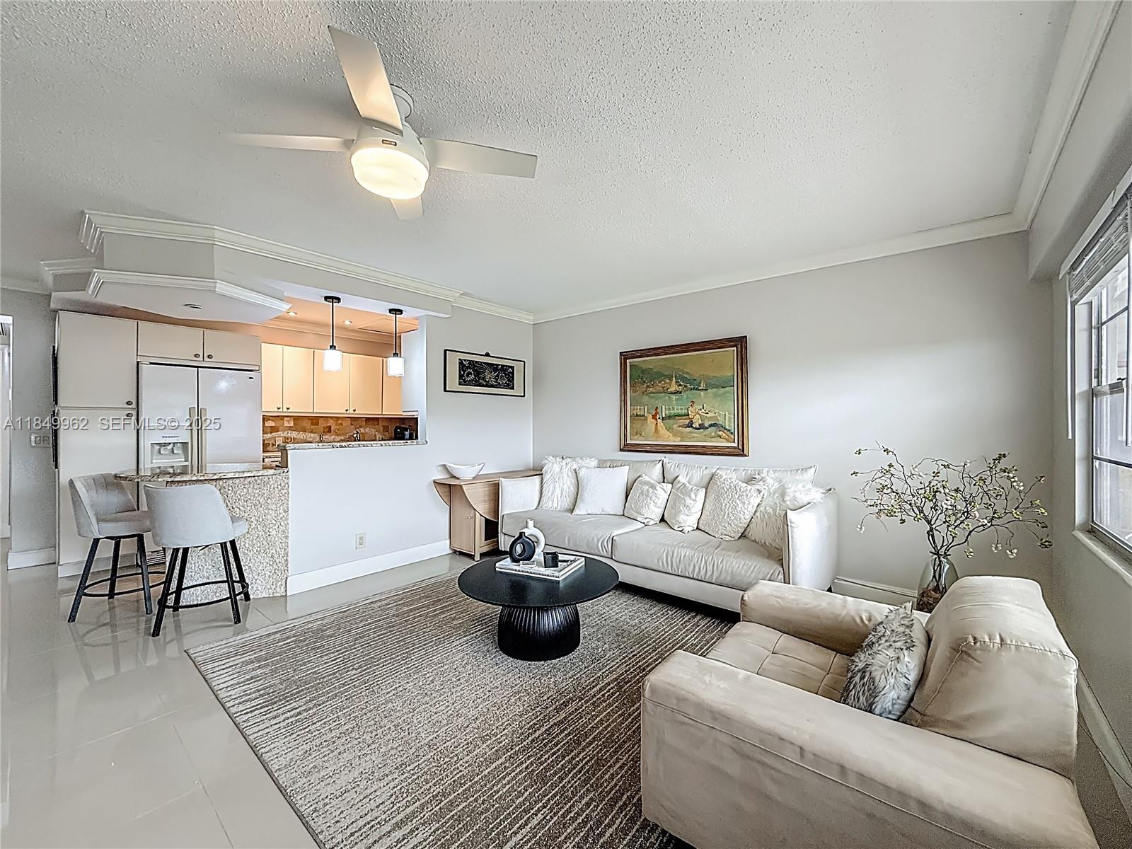 618 Fanshaw O, Unit 618 Boca Raton, FL 33434 - Photo 8 of 40 a living room with furniture and a flat screen tv