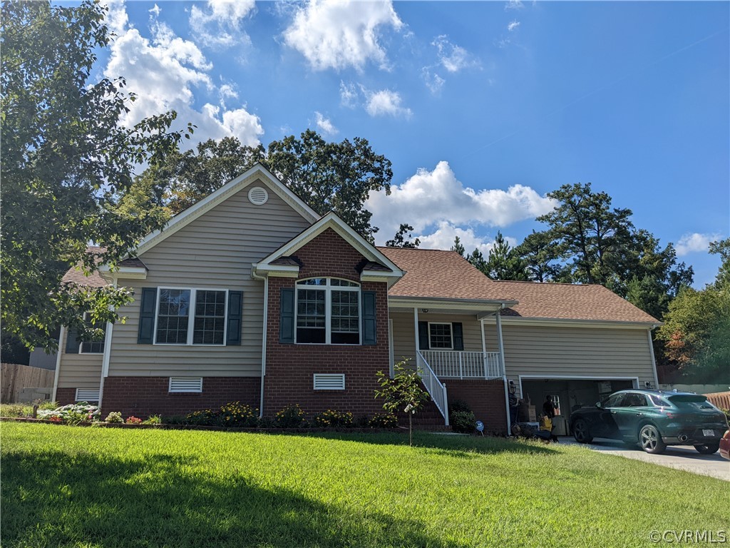 a view of a house with a yard and sitting area