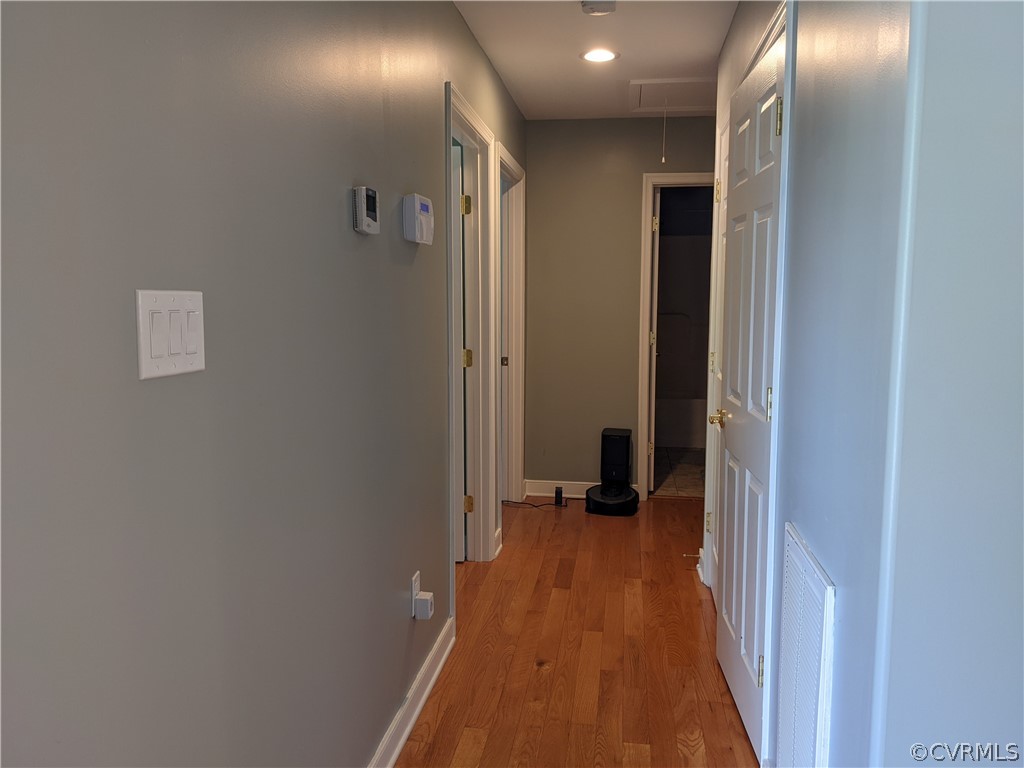 11624 Hillside Road Chester, VA 23831 - Photo 11 of 20 a view of a hallway with wooden floor and a bathroom