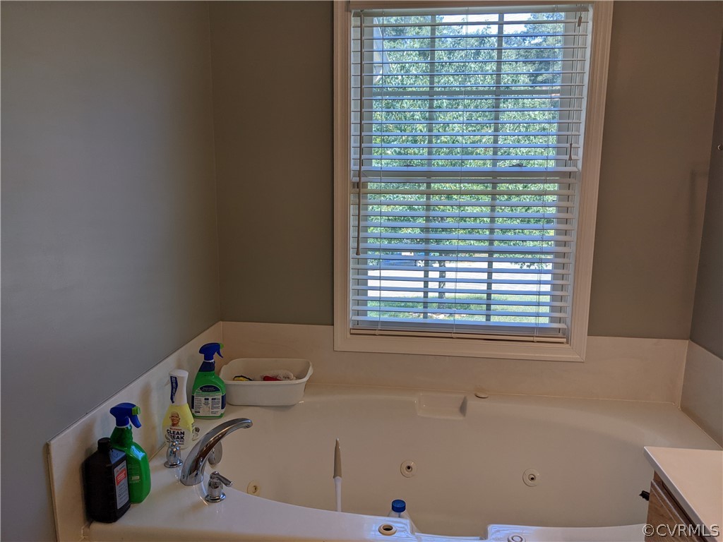 11624 Hillside Road Chester, VA 23831 - Photo 15 of 20 a bathroom with a bathtub and a window