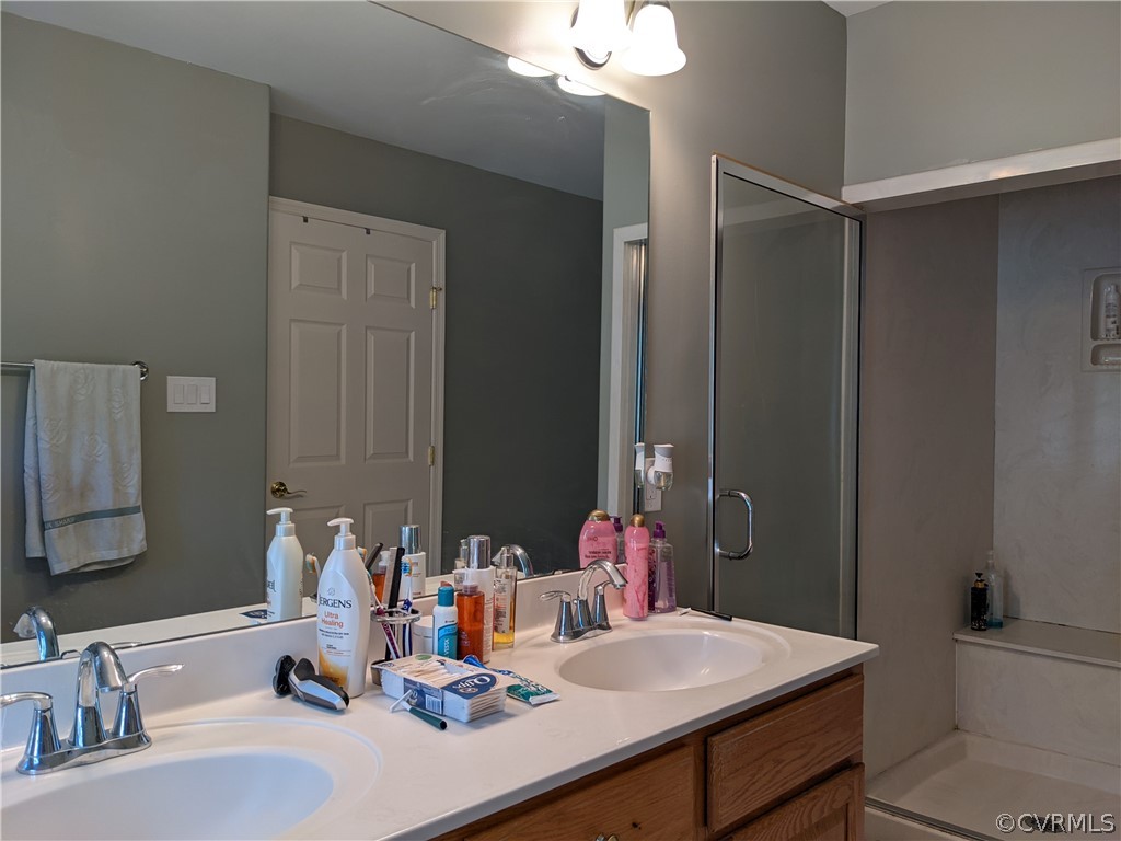 11624 Hillside Road Chester, VA 23831 - Photo 16 of 20 a bathroom with a sink vanity and a mirror