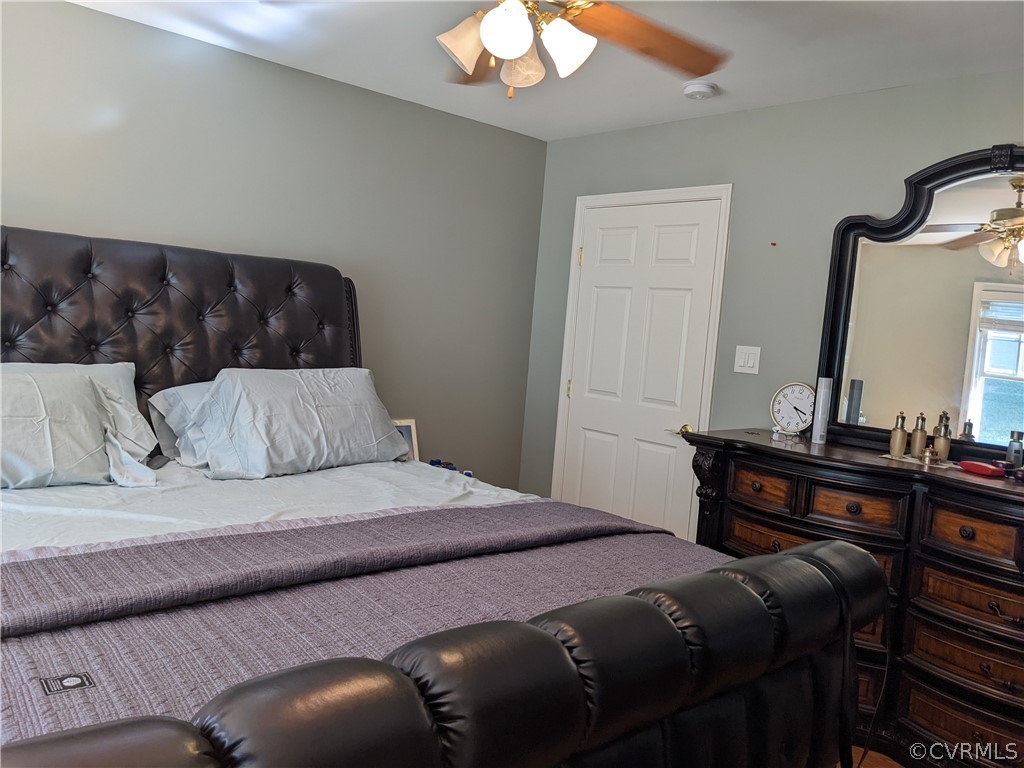 11624 Hillside Road Chester, VA 23831 - Photo 18 of 20 a bedroom with a bed lamp and a mirror on the dresser