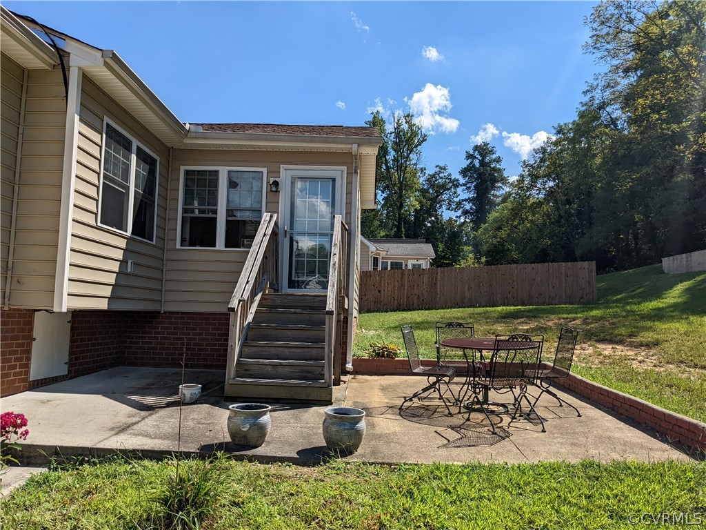 11624 Hillside Road Chester, VA 23831 - Photo 3 of 20 a view of a patio with table and chairs potted plants with wooden floor and fence