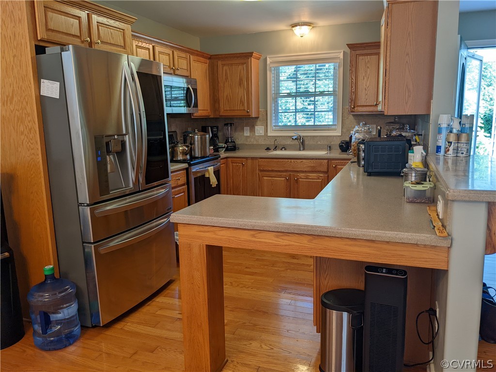 11624 Hillside Road Chester, VA 23831 - Photo 8 of 20 a kitchen with a refrigerator sink and microwave