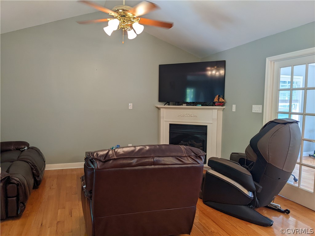 11624 Hillside Road Chester, VA 23831 - Photo 9 of 20 a living room with furniture a flat screen tv and a fireplace