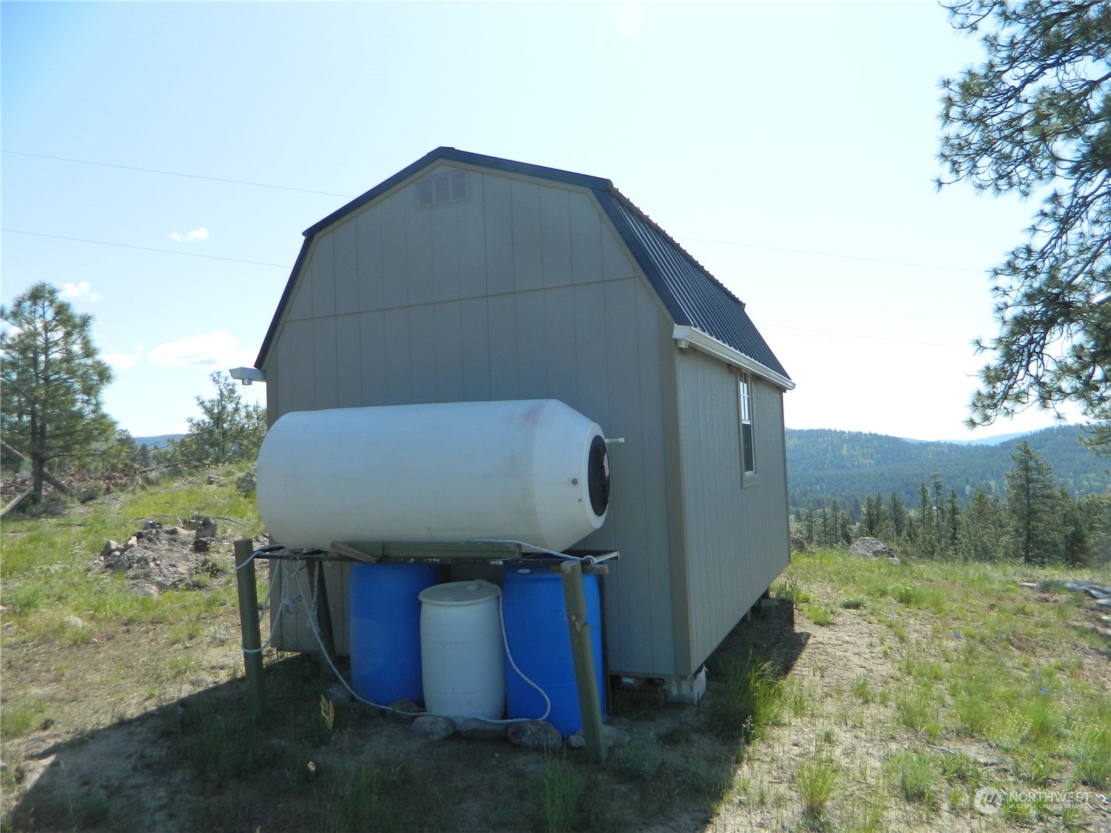 153 Neil Canyon Road Tonasket, WA 98855 - Photo 3 of 24 a backyard of a house with lots of green space