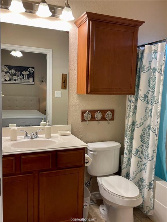 1198 Jones-Butler Road, Unit 3009 College Station, TX 77840 - Photo 11 of 20 a bathroom with a sink a toilet a mirror and shower curtain
