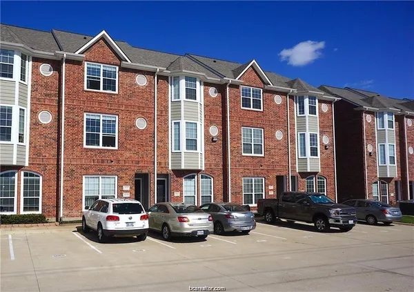 a car parked in front of a brick house