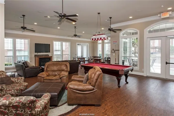 a living room with furniture a ceiling fan and a window