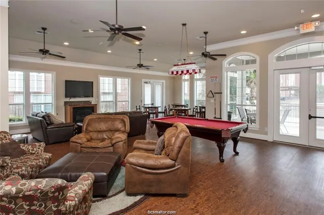 a living room with furniture a ceiling fan and a window