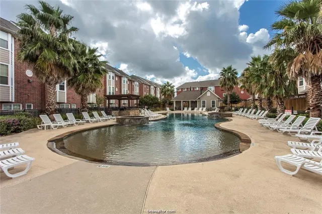 a view of a swimming pool with outdoor seating