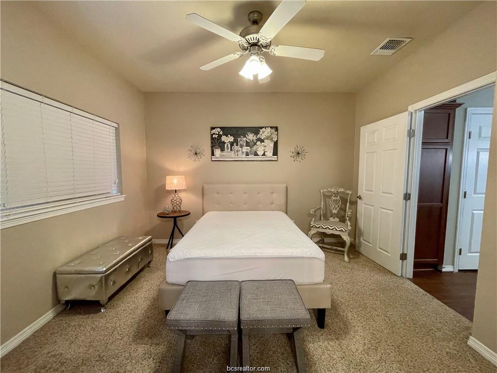 1198 Jones-Butler Road, Unit 3009 College Station, TX 77840 - Photo 10 of 20 a bedroom with a bed and a chandelier
