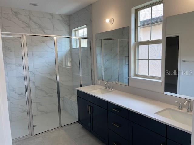 7501 Wing Span Way Harmony, FL 34773 - Photo 11 of 30 a bathroom with a double vanity sink and a mirror