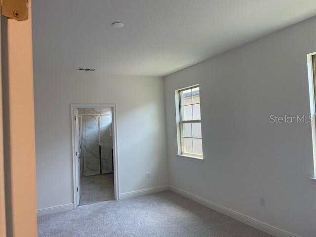 7501 Wing Span Way Harmony, FL 34773 - Photo 13 of 30 an empty room with windows and closet