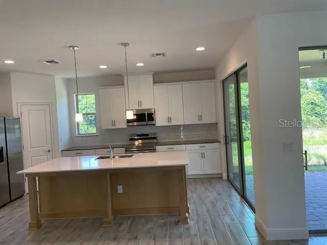 a kitchen with a refrigerator and a sink