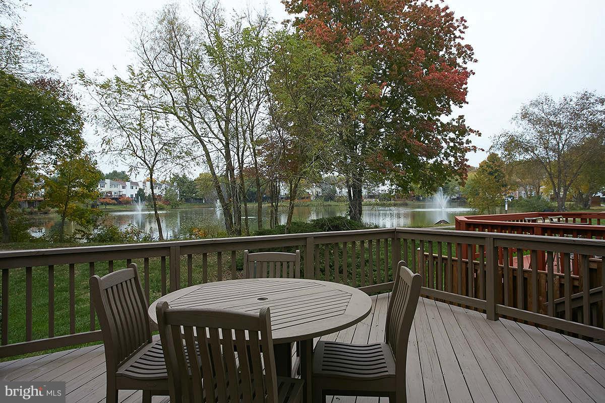 a view of a deck with furniture and trees