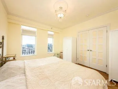 a bedroom with a bed and a chandelier