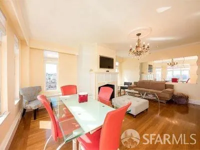 a living room with furniture a fireplace and a dining table