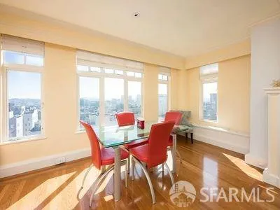 a dining room with furniture and wooden floor