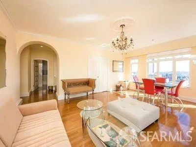 a living room with fireplace furniture and a chandelier