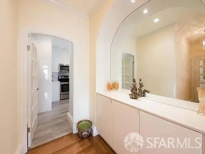 a bathroom with a sink mirror and vanity