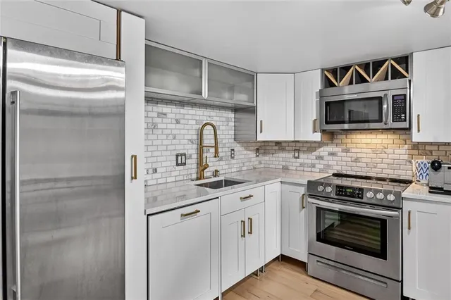 a kitchen with stainless steel appliances a refrigerator and a sink