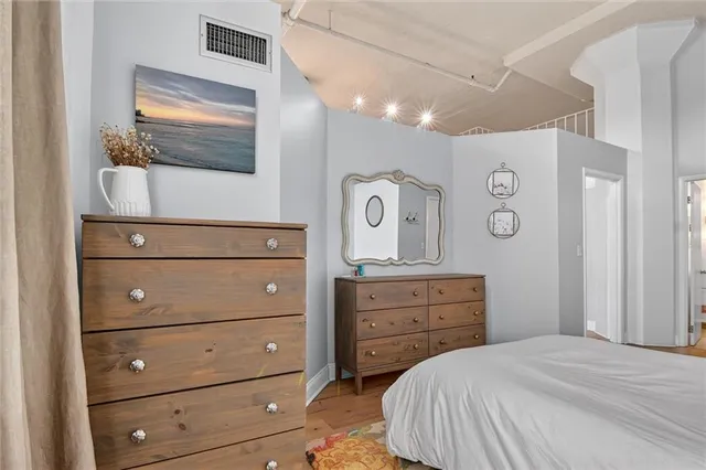 a bathroom with a toilet sink vanity and mirror